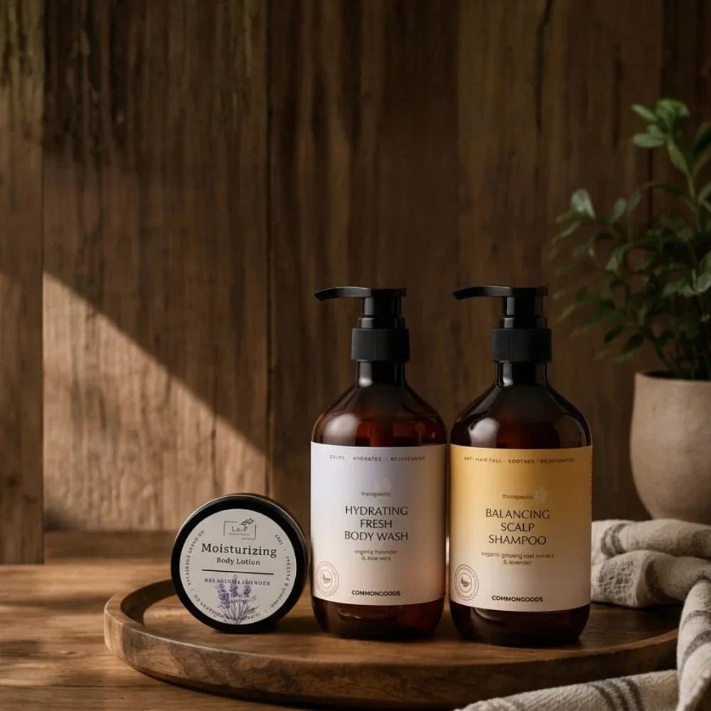 Common Goods body wash and shampoo on a wooden tray