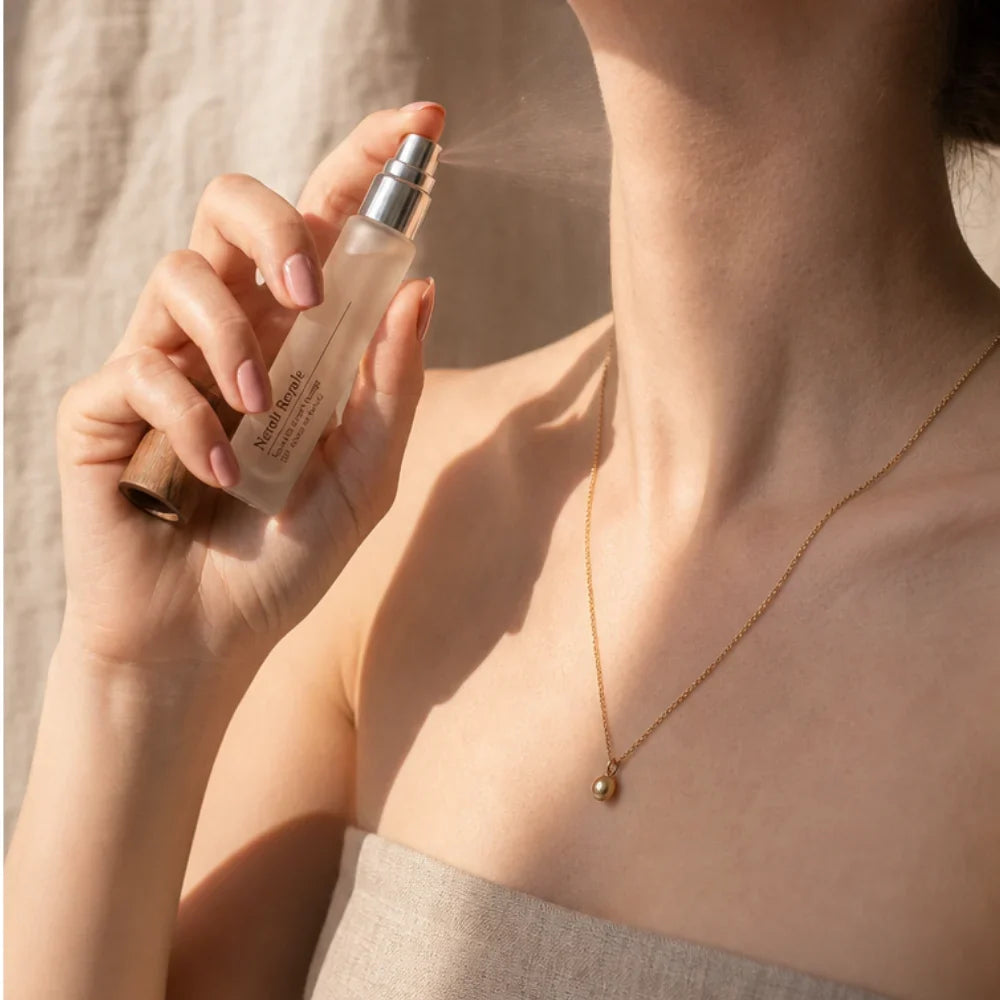 Applying perfume to the neck
